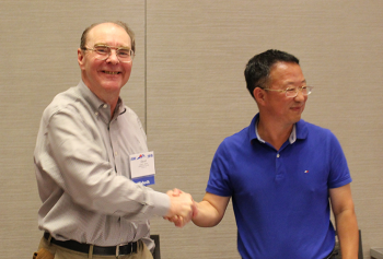 David Banks, SAMSI Director and Zhang Riquan, East China Normal University shaking hands.